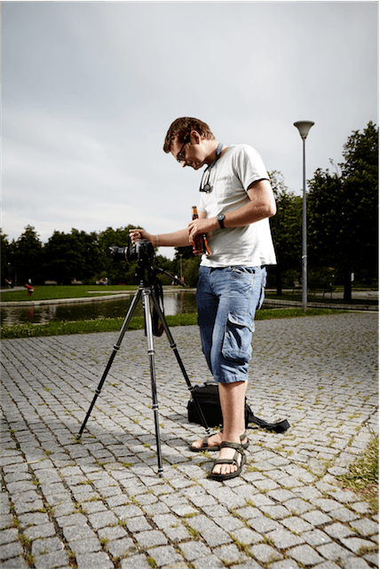 man camera photographer portrait tripod settings shorts glasses DSLR