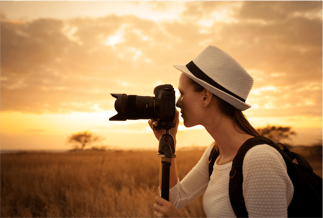 lady camera hat wild sunset tripod photographer