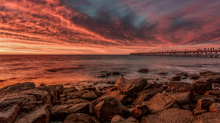 landscape water rocks pier sunset red pink