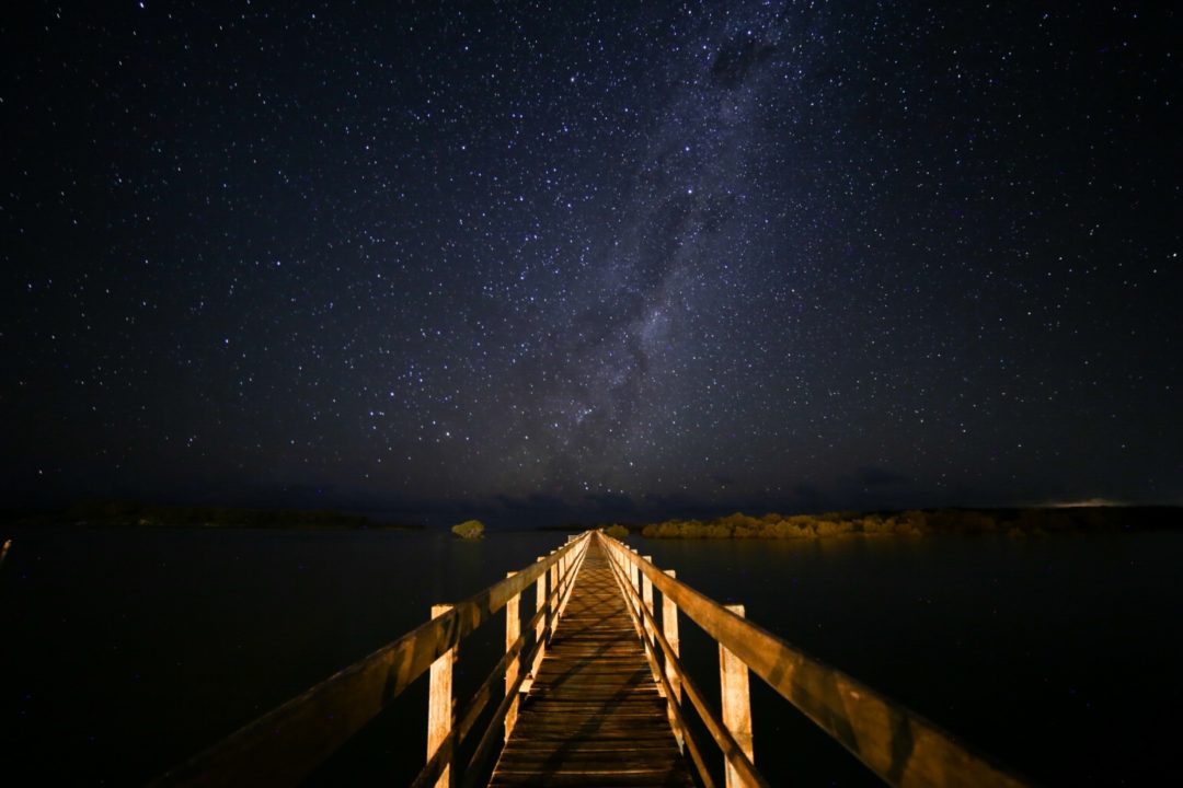 stars night pier leading lines milky way flash shadow
