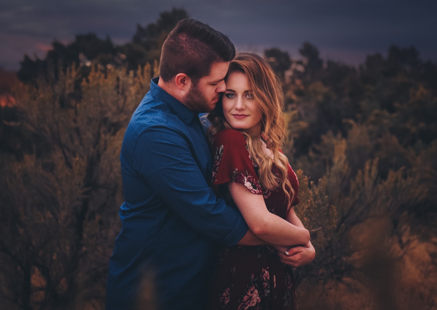engagement couple cuddly dark muted field love