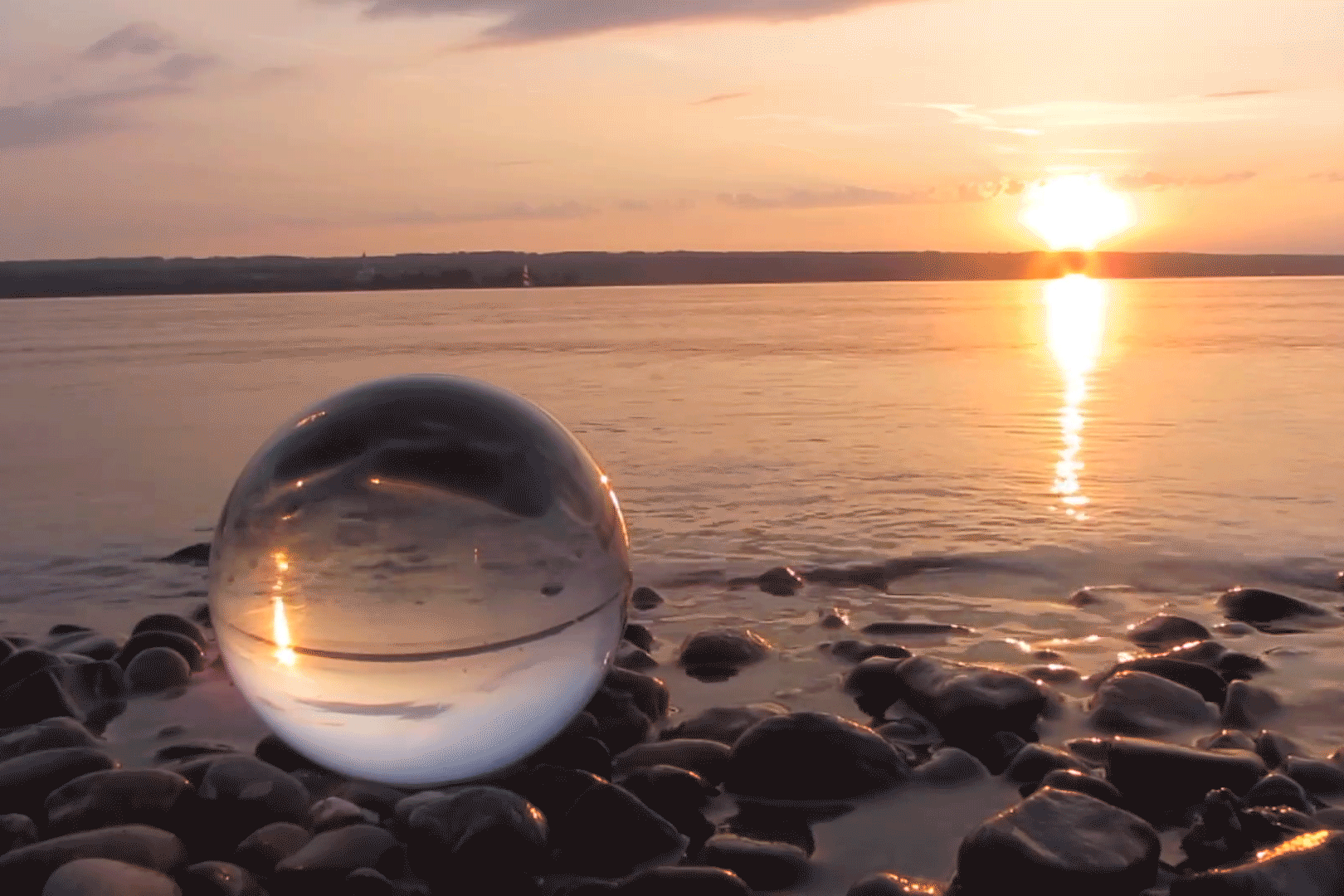 cinemagraph moving image glass ball water sunset beach rocks stones coast tide