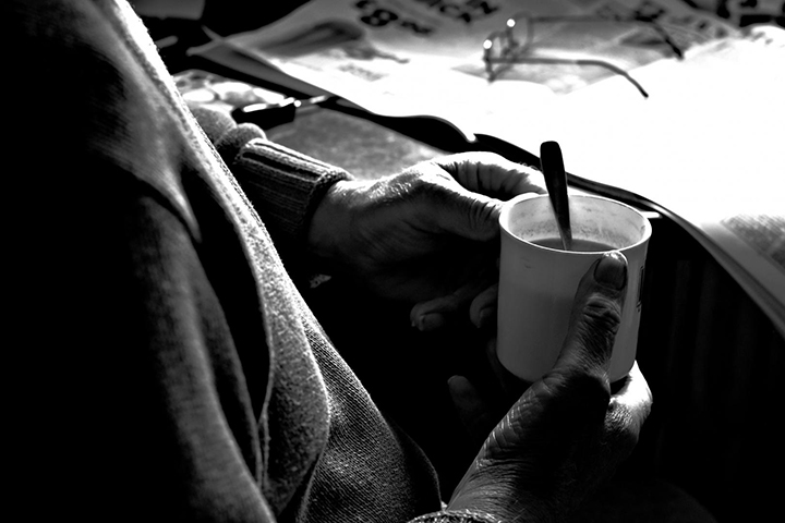 hands holding a cup with a spoon in it street photography portrait city people camera subject light how to tutorial guide