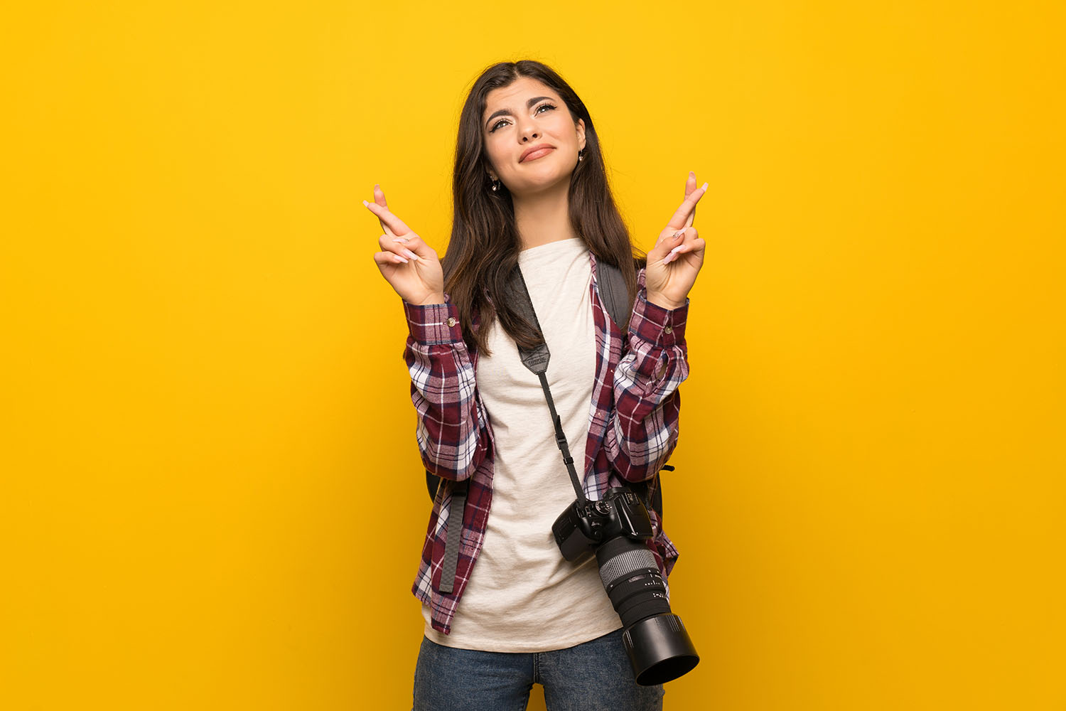fingers crossed model on yellow