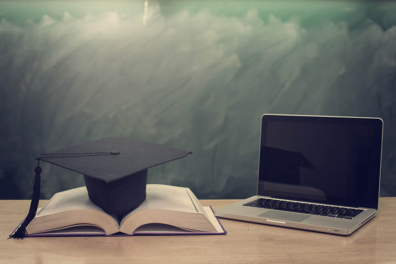 college degree graduation cap computer online training course